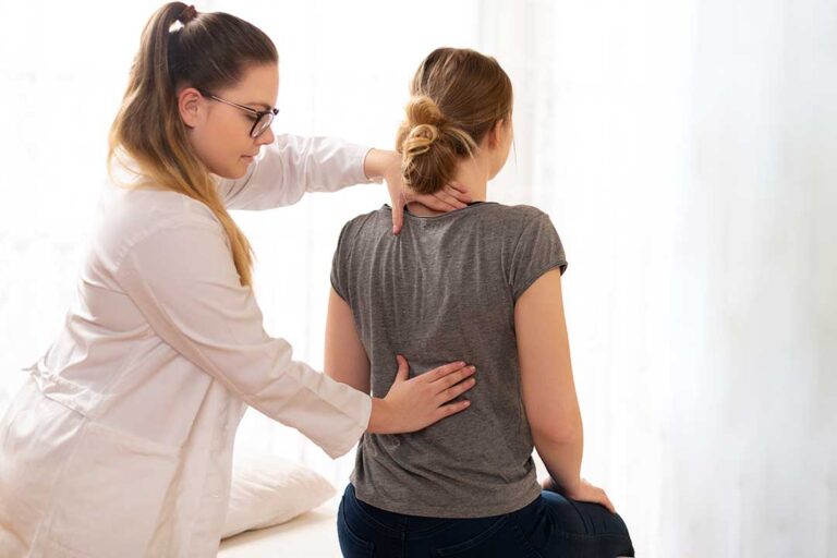 Person seated at home doing a gentle knee exercise with an ice pack and resistance band nearby